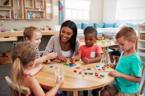 Teacher with students at table